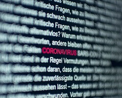 A close-up of text on a display screen with the word "coronavirus" highlighted in red.