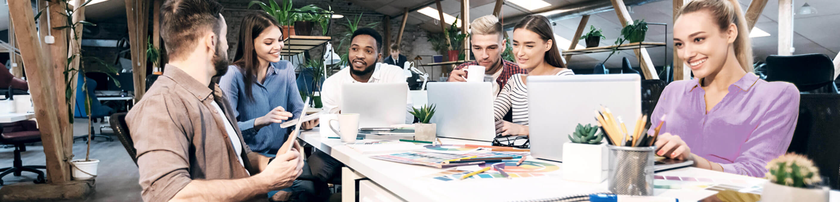 young professionals around a laptop