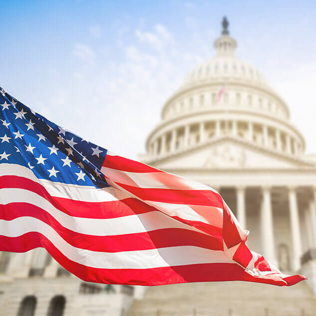 American flag in front of the U.S. Capitol building. 