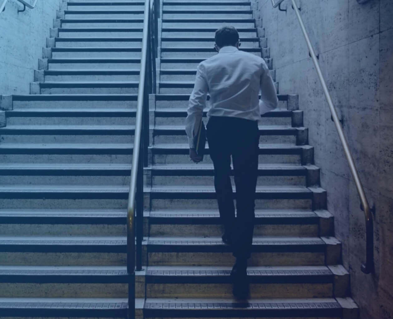 Professional man walking up a flight of stairs. 