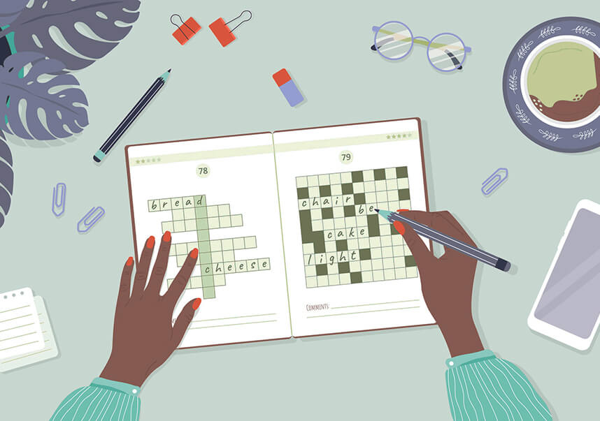 A person's hands working on a crossword puzzle on a table with coffee and a phone. 