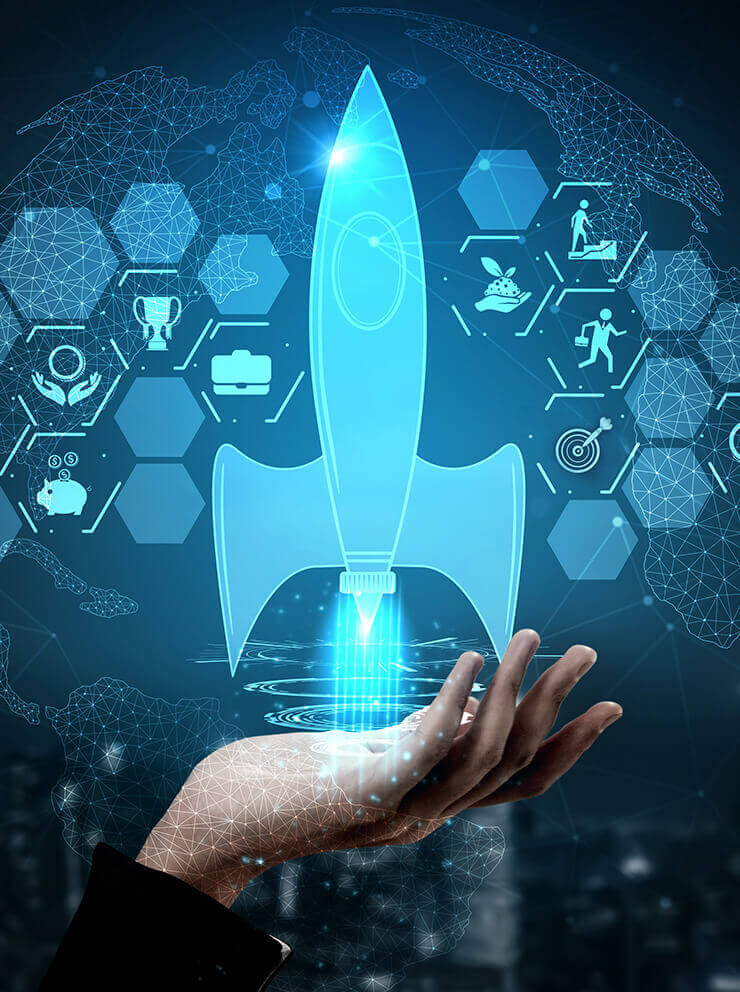 Closeup of a hand with the graphic image of a bright blue rocket and other icons against a dark blue background.