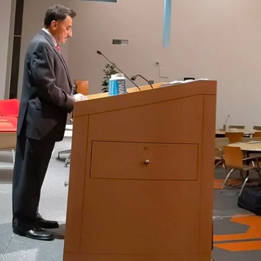 Side view of ANSI CEO Joe Bhatia speaking at a podium.