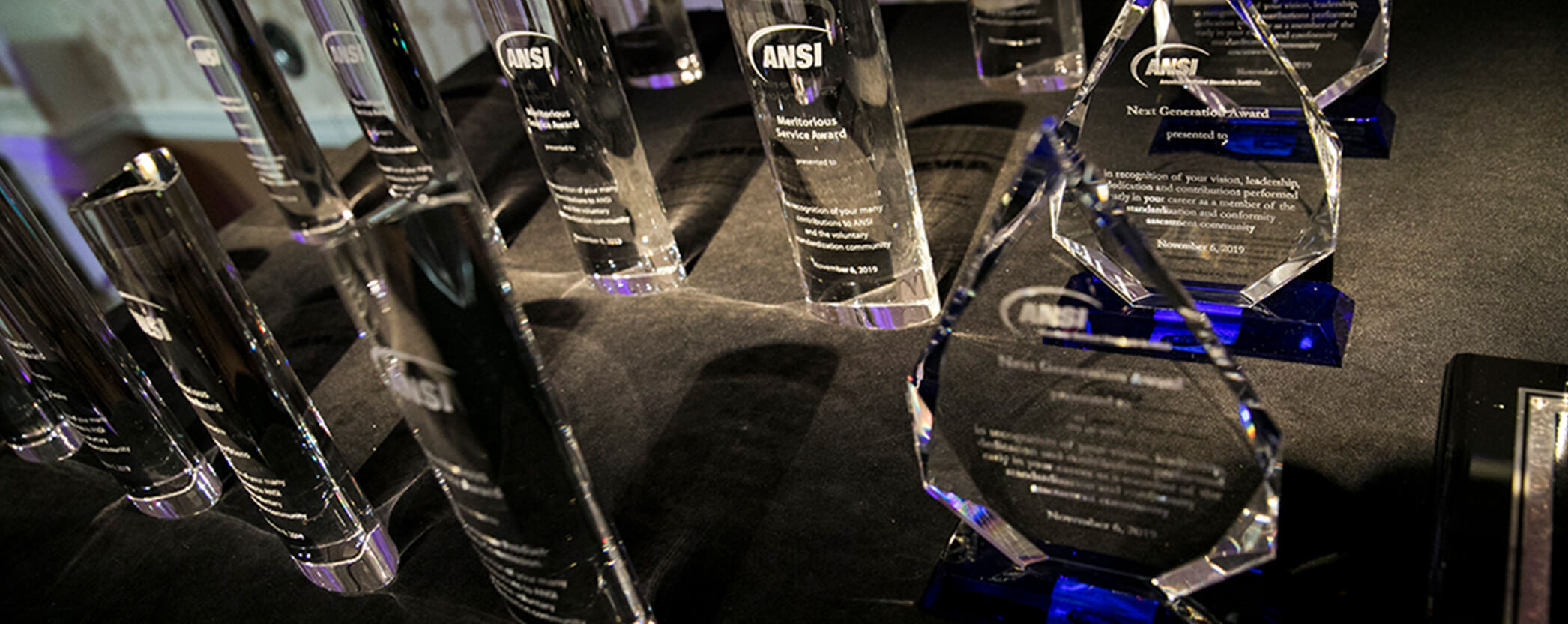 glass awards lined up on a table