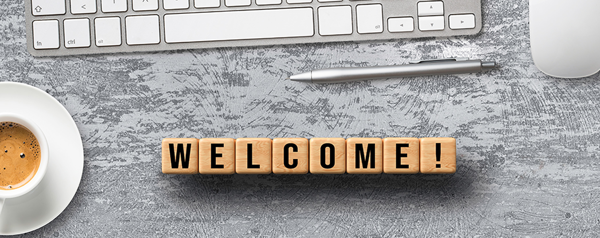 The word welcome in block letters on a desk