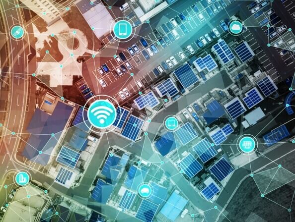 Aerial view of a city with abstract connection and technology icons superimposed. 