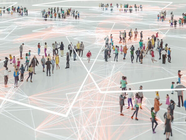 An aerial image of many people networking in groups, connected by a pattern of abstract lines.